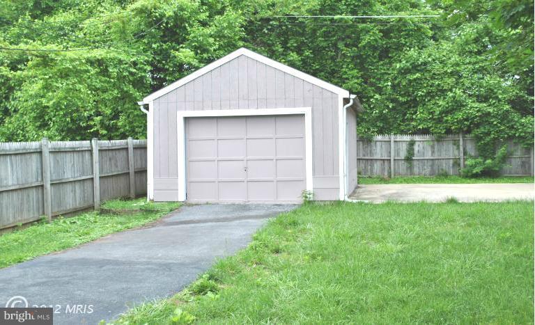 2820 Greenlawn Road Baltimore, MD 21207 - Photo 15 of 26 a front view of a house with a yard and garage