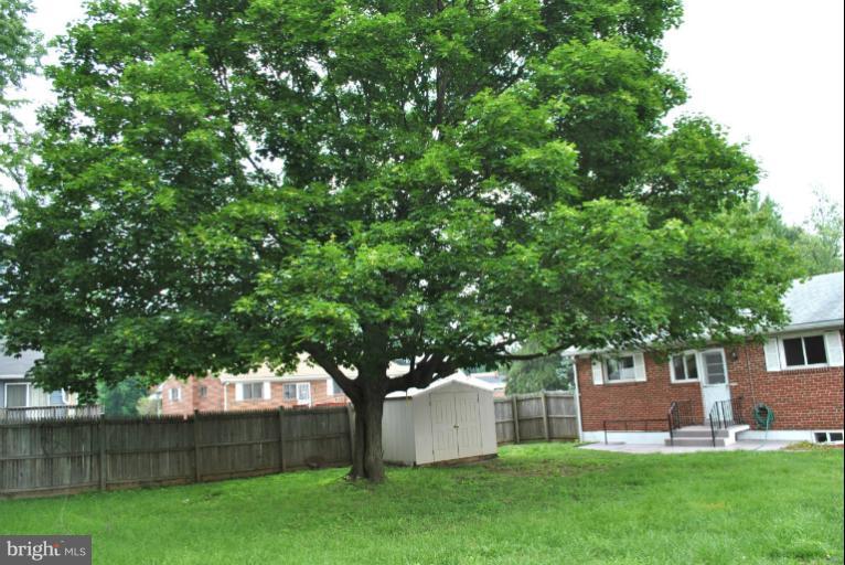 2820 Greenlawn Road Baltimore, MD 21207 - Photo 3 of 26 a view of a house with a yard and a large tree