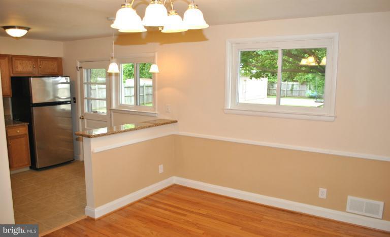 2820 Greenlawn Road Baltimore, MD 21207 - Photo 22 of 26 a view of an empty room with wooden floor and a window