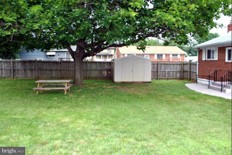 2820 Greenlawn Road Baltimore, MD 21207 - Photo 23 of 26 a view of a backyard with a garden and tree