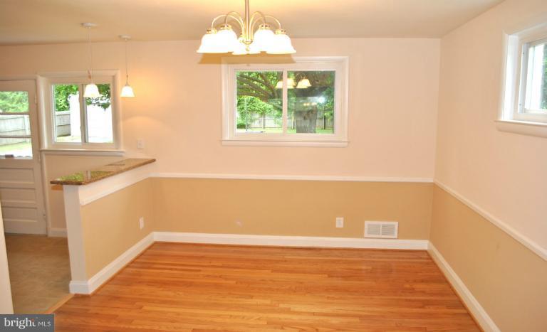 2820 Greenlawn Road Baltimore, MD 21207 - Photo 25 of 26 a view of an empty room with wooden floor and a window