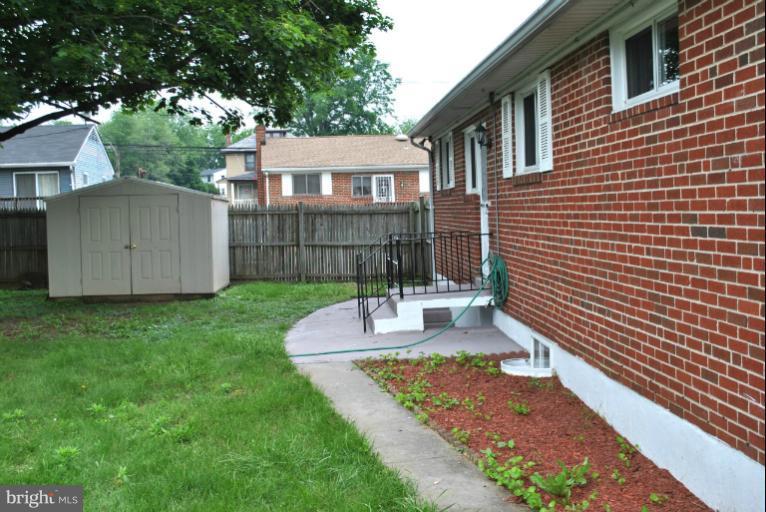 2820 Greenlawn Road Baltimore, MD 21207 - Photo 10 of 26 a front view of a house with garden
