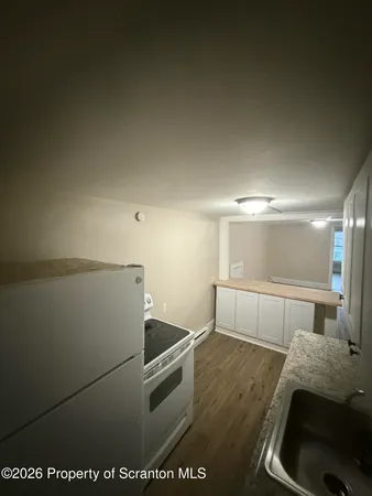 a room with a bed and a dresser