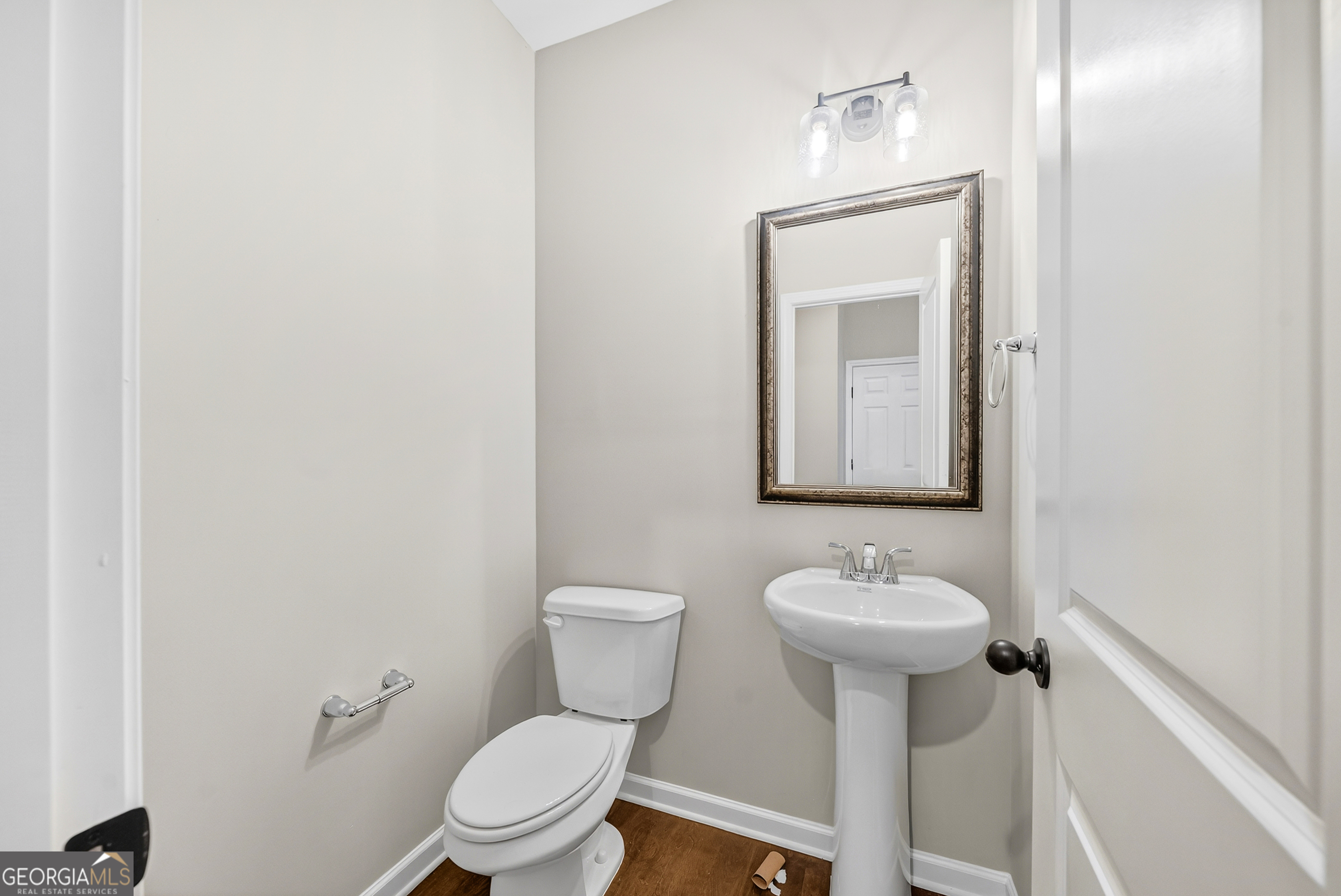 38 Oak Ridge Drive, Unit 26 Waverly Hall, GA 31831 - Photo 18 of 37 a bathroom with a toilet sink and mirror