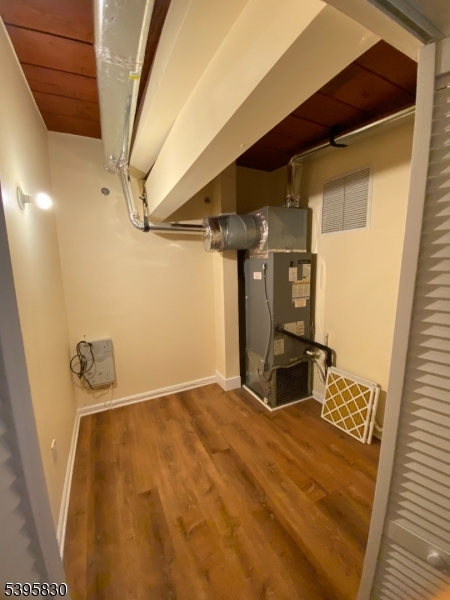 262 Main Street Little Falls, NJ 07424 - Photo 15 of 16 a bedroom with a bed and wooden floor