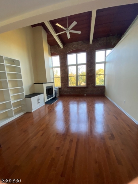 262 Main Street Little Falls, NJ 07424 - Photo 3 of 16 a view of a livingroom with wooden floor and a ceiling fan