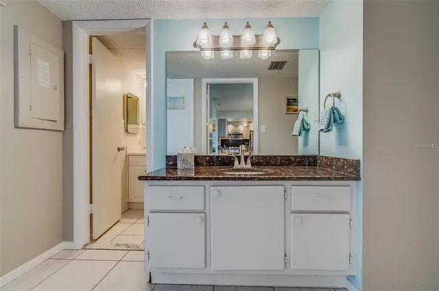 a bedroom with two beds and a chandelier