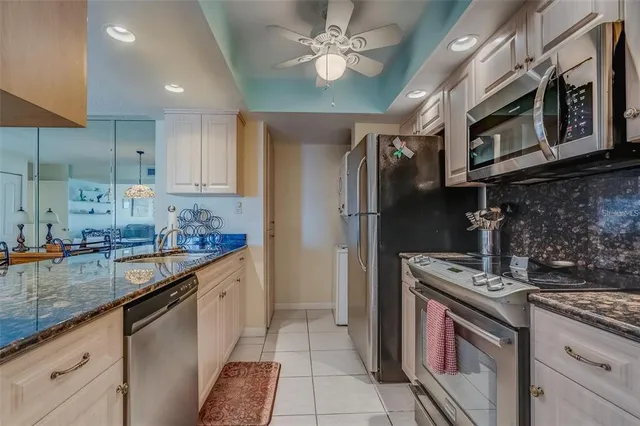 a kitchen with stainless steel appliances granite countertop a refrigerator and a sink