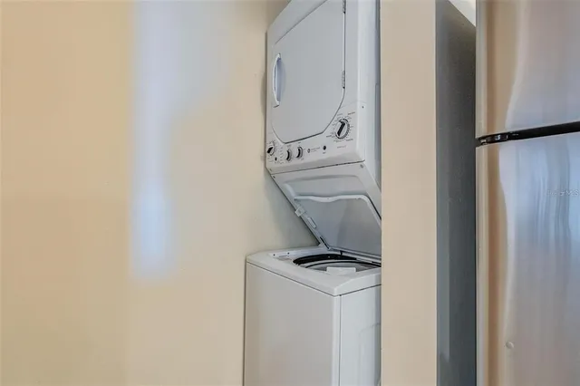 a kitchen with kitchen island granite countertop a sink cabinets and stainless steel appliances