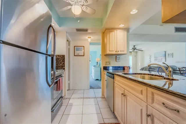 a view of a dining room and livingroom with furniture wooden floor a chandelier