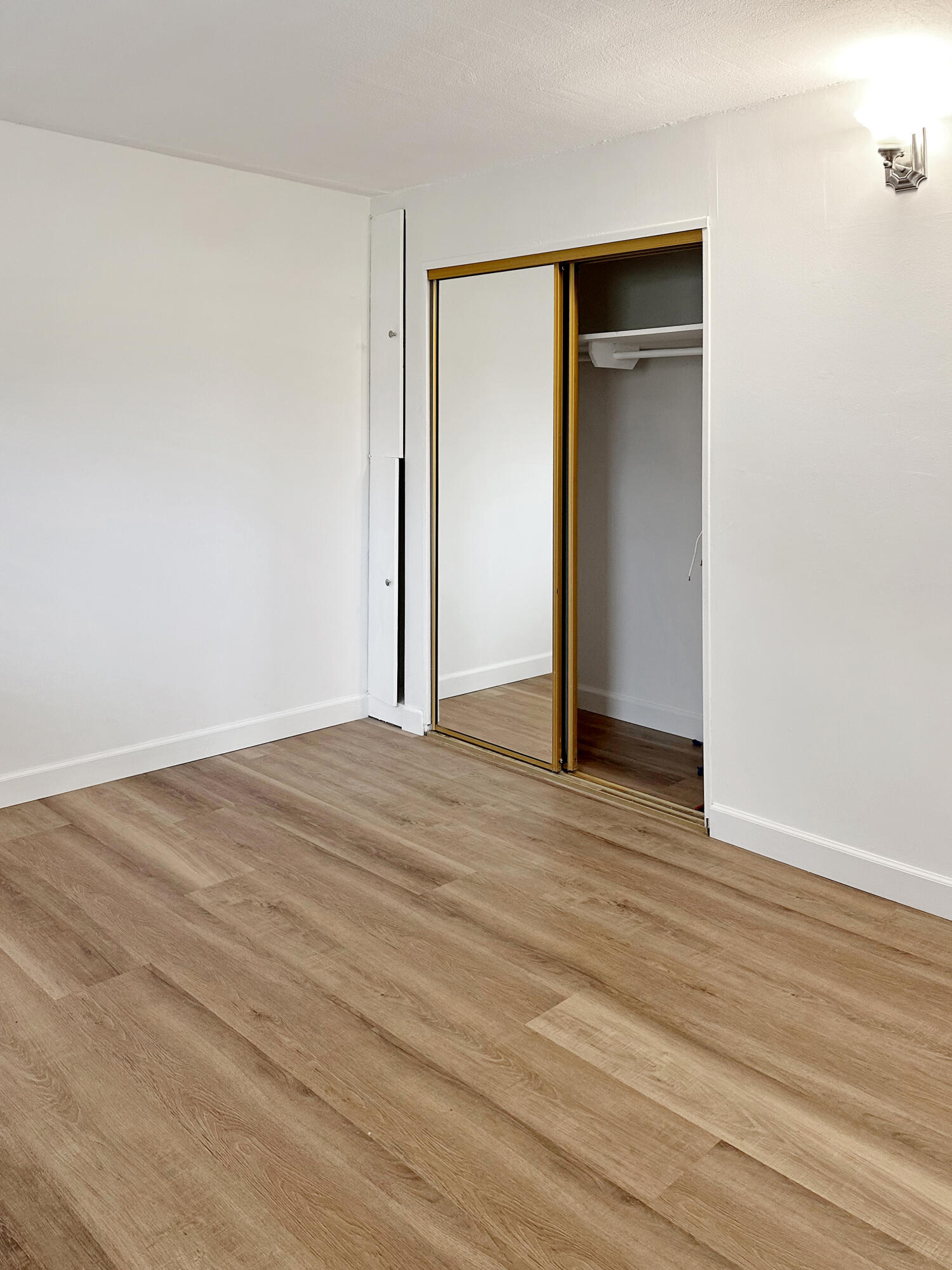 5740 Encina Road, Unit 3 Goleta, CA 93117 - Photo 17 of 23 an empty room with wooden floor and closet