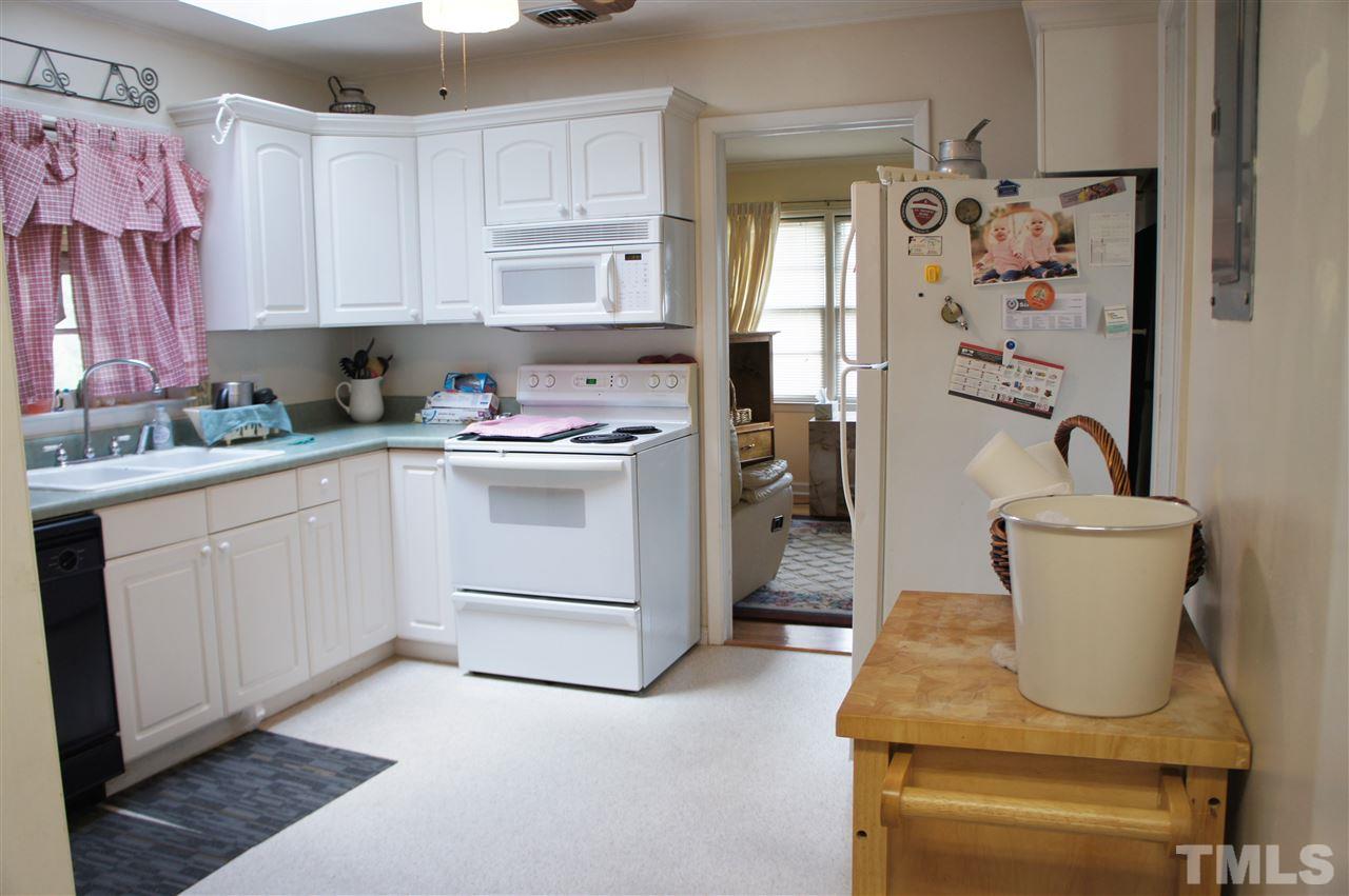 2832 Poole Road Raleigh, NC 27610 - Photo 11 of 16 a kitchen with a white stove top oven and white cabinets
