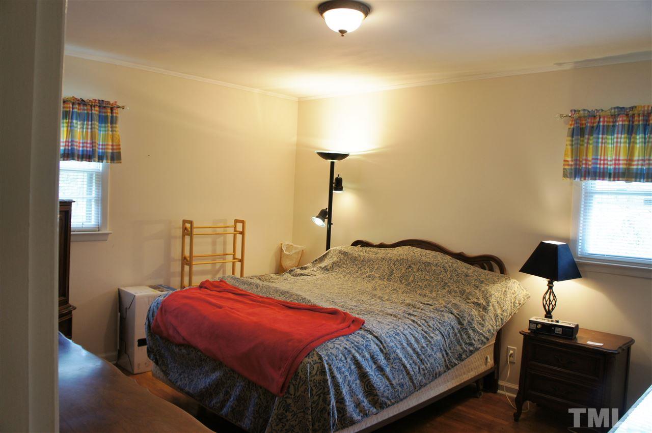 2832 Poole Road Raleigh, NC 27610 - Photo 4 of 16 a bedroom with a bed and window