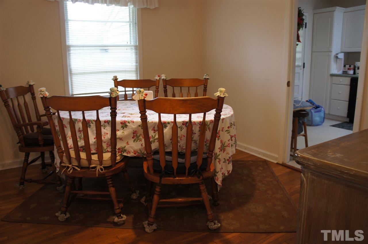 2832 Poole Road Raleigh, NC 27610 - Photo 7 of 16 a view of a dining room with furniture window and wooden floor