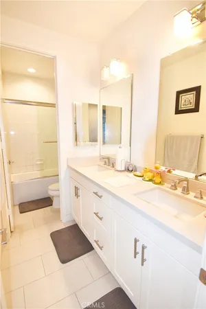 a bathroom with a sink vanity mirror and toilet