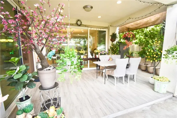 a view of a dining room with furniture and a potted plant