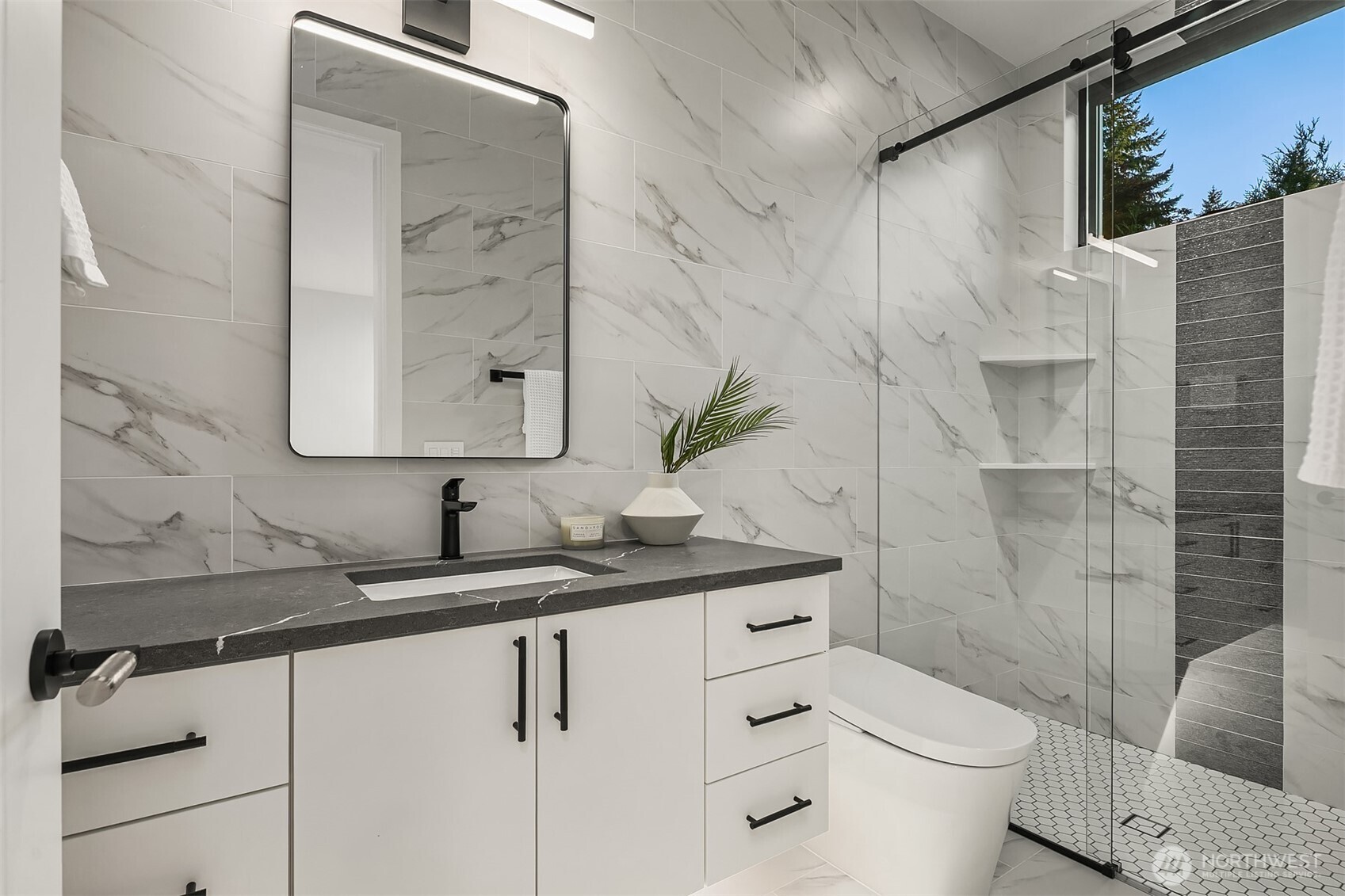7626 Northeast 10th Street Medina, WA 98039 - Photo 17 of 40 a bathroom with a granite countertop sink a toilet and shower