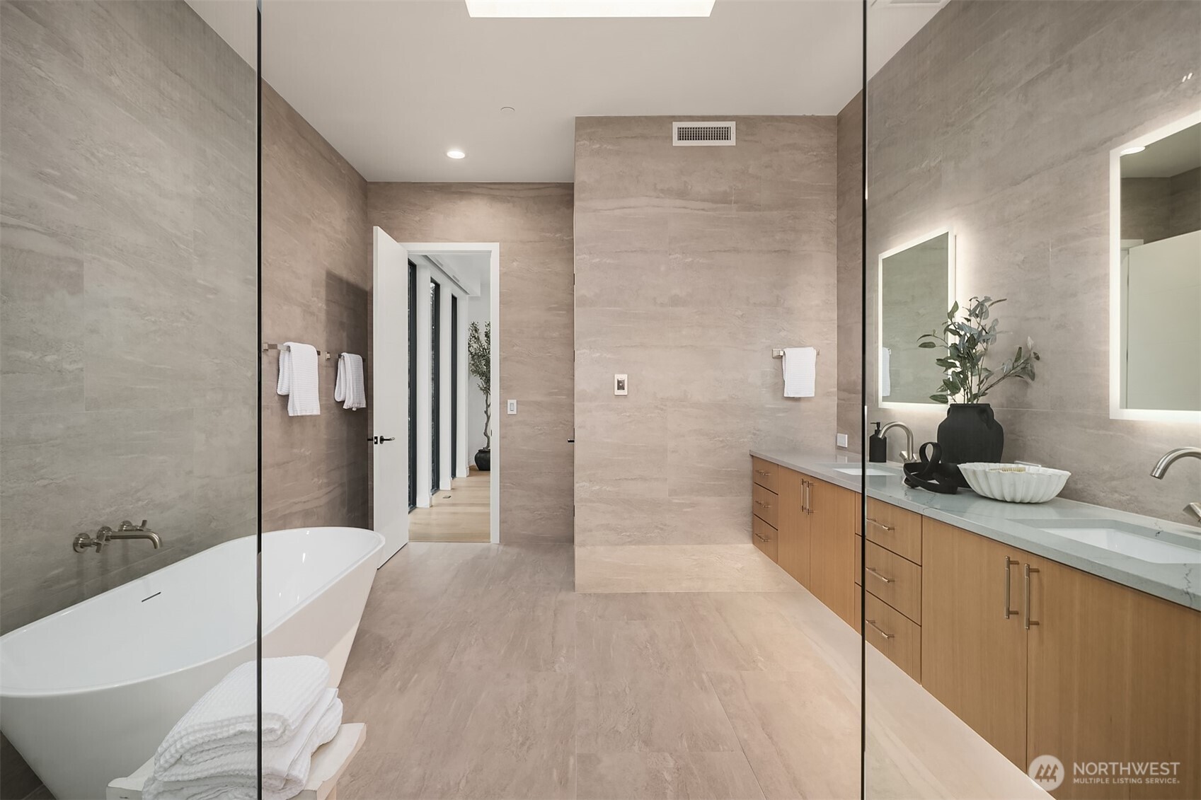 7626 Northeast 10th Street Medina, WA 98039 - Photo 21 of 40 a bathroom with a granite countertop sink a bathtub and shower