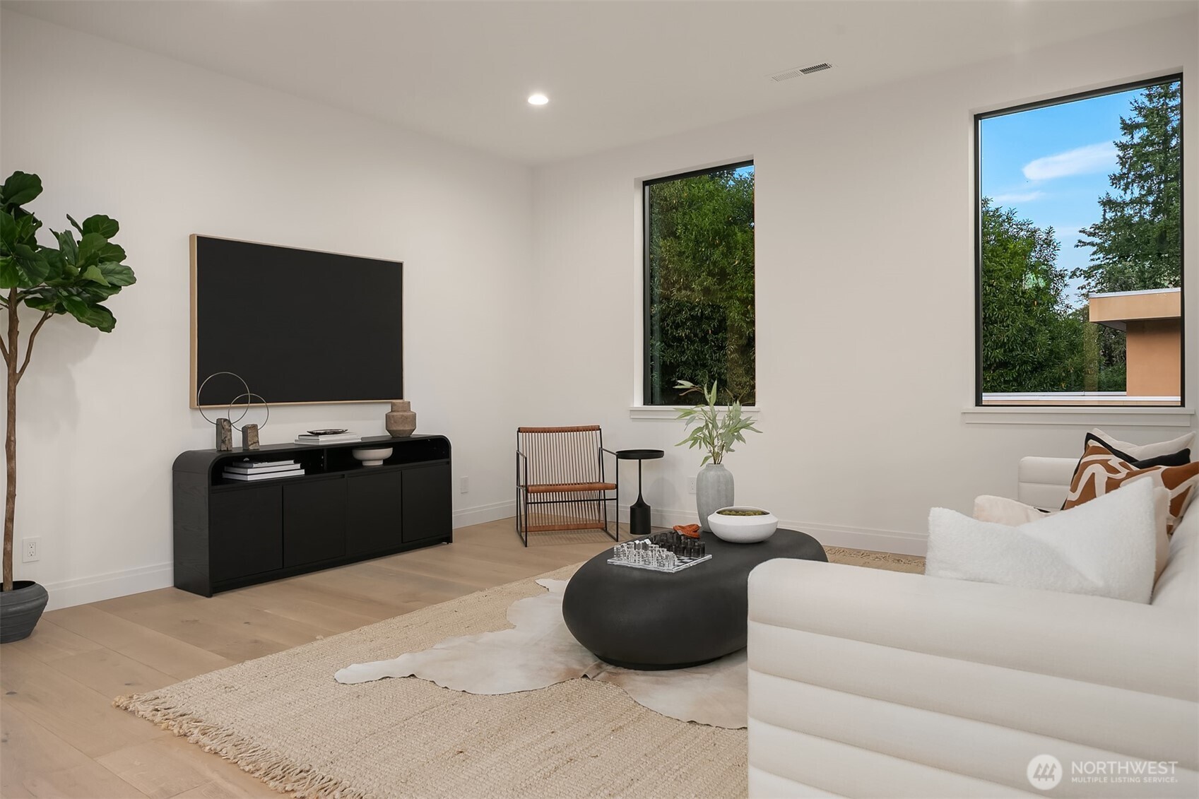 7626 Northeast 10th Street Medina, WA 98039 - Photo 28 of 40 a living room with furniture and a flat screen tv