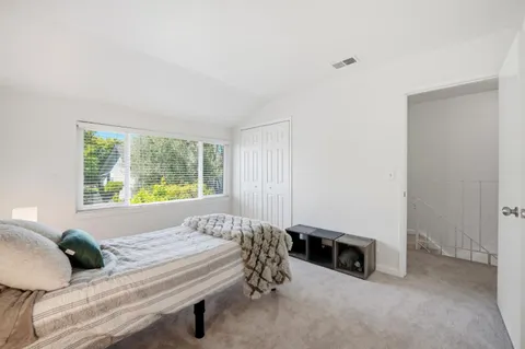 a bedroom with a bed and a closet