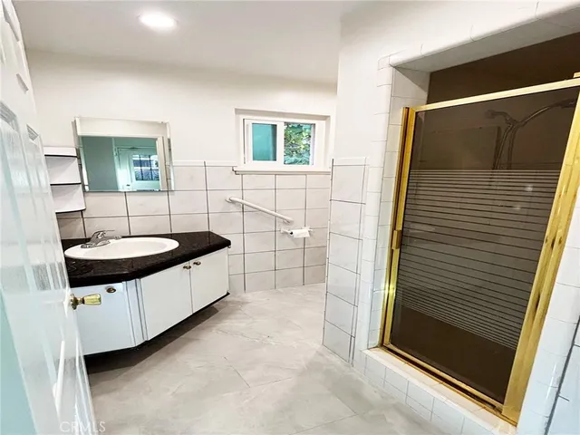 a bathroom with a tub sink and mirror