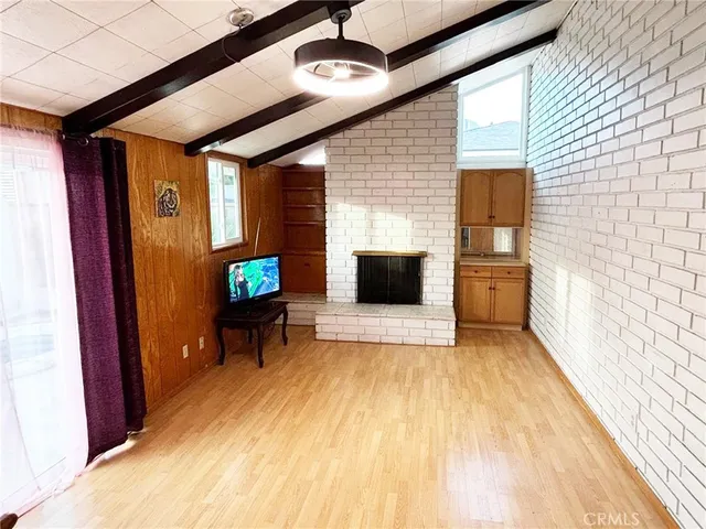 a view of a livingroom with furniture and a flat screen tv