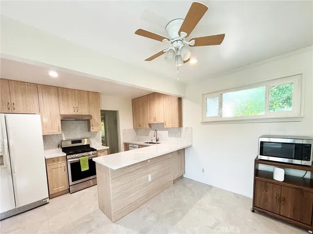 a kitchen with a refrigerator and a sink