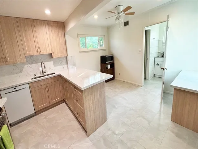 a kitchen with a sink a stove a refrigerator and a window