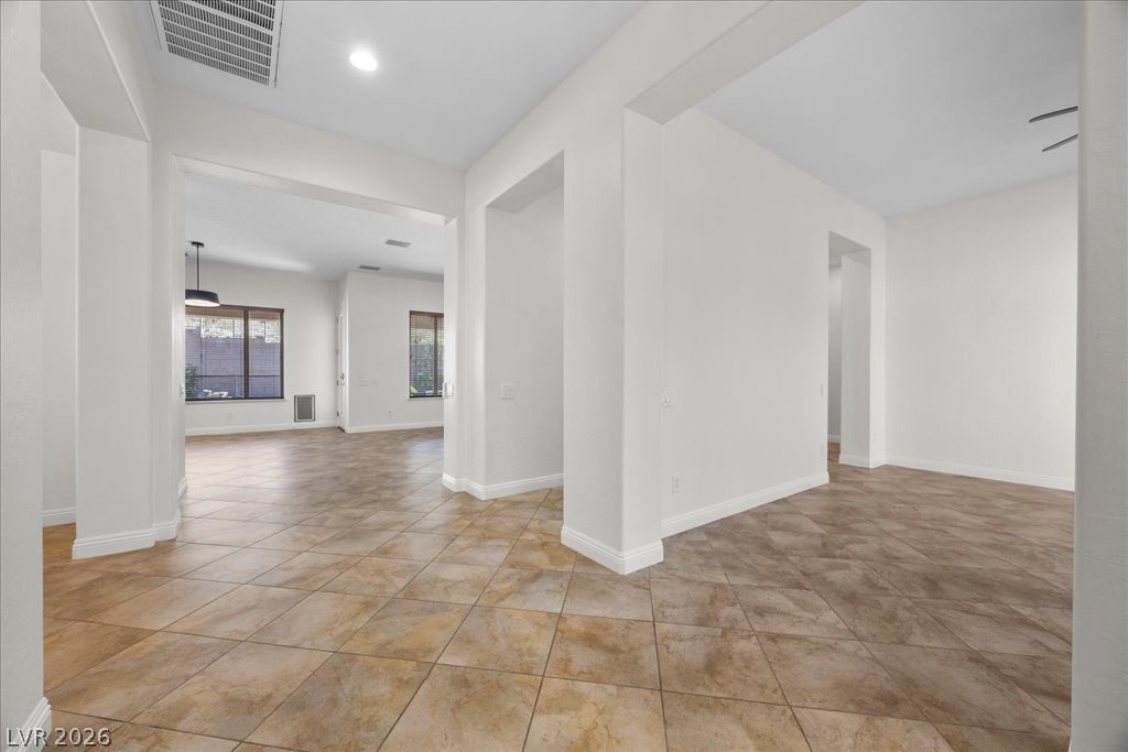 2125 De Rouge Avenue Henderson, NV 89044 - Photo 33 of 96 Clean tile flooring extends throughout this naturally illuminated, open concept living area.