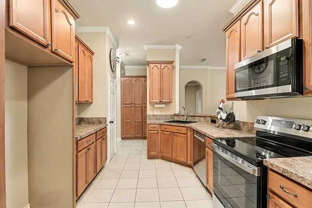 a kitchen with stainless steel appliances granite countertop a stove a sink and a microwave
