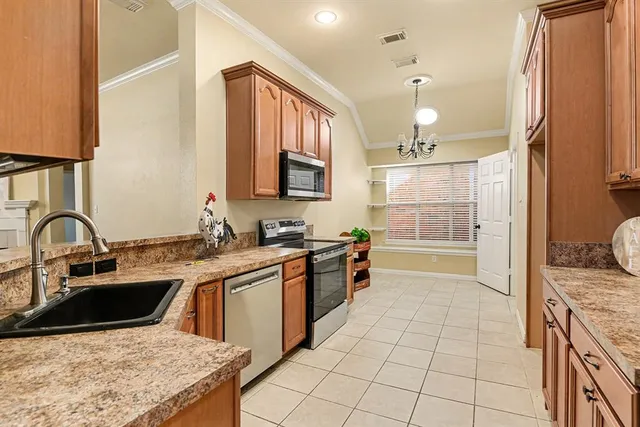 a view of a refrigerator a stove a sink and a window