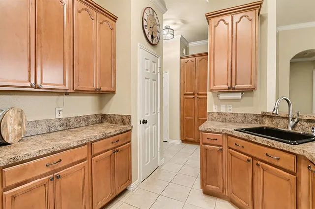 a kitchen with a sink stove and cabinets
