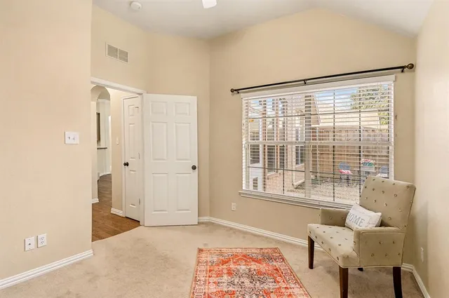 a view of a bedroom with furniture and window