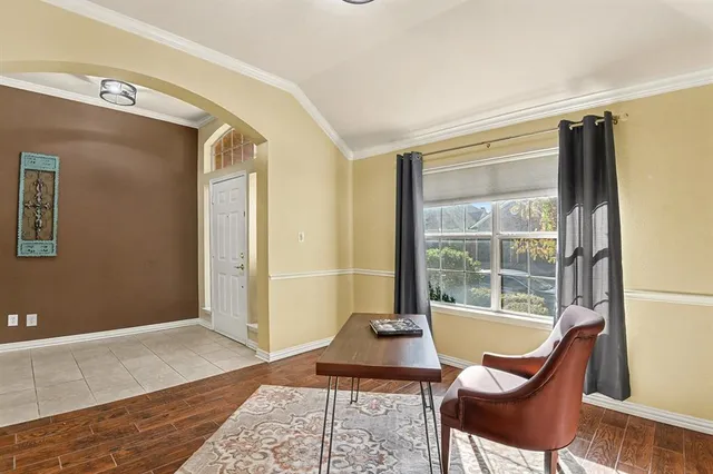 a view of a hallway with windows and wooden door