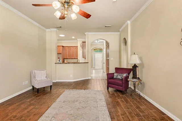 a living room with furniture a fireplace and a chandelier