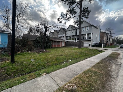1240 West 26th Street Houston, TX 77008 - Photo 3 of 6 a view of a white house with a big yard and large tree