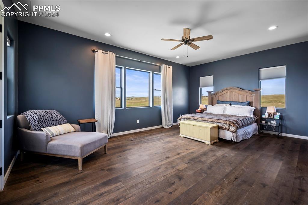 24365 Murphy Road Calhan, CO 80808 - Photo 29 of 50 a spacious bedroom with a bed and a chandelier