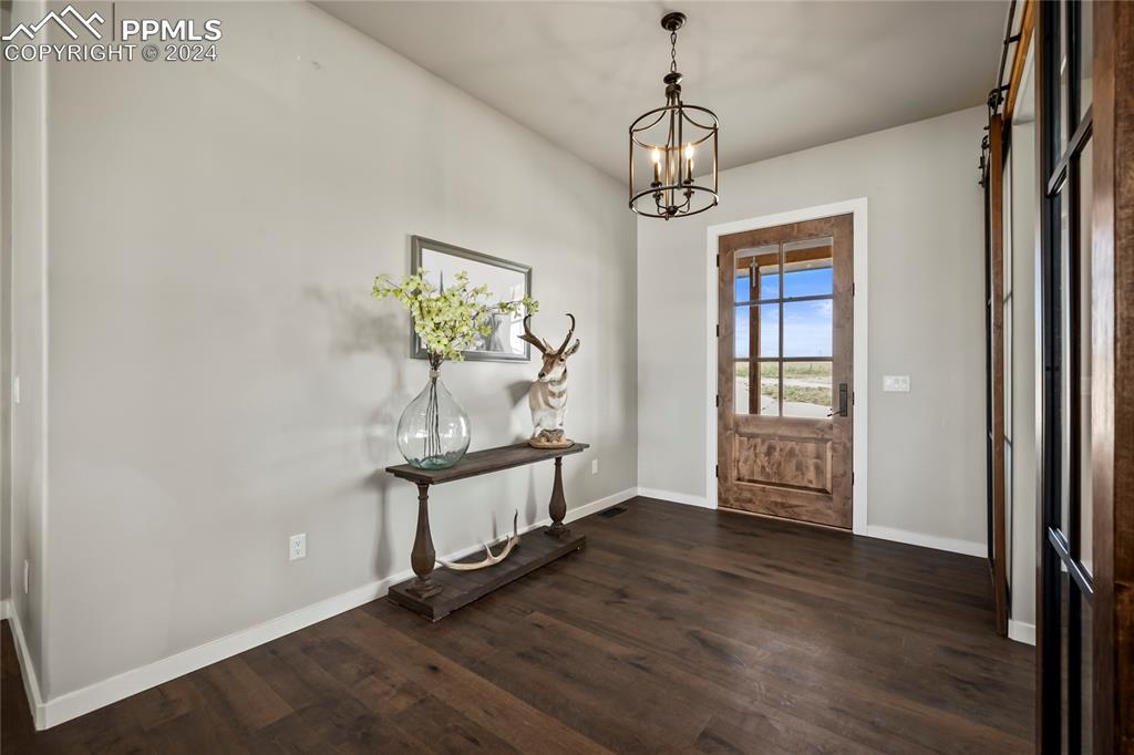 24365 Murphy Road Calhan, CO 80808 - Photo 9 of 50 a view of a room with wooden floor staircase and windows