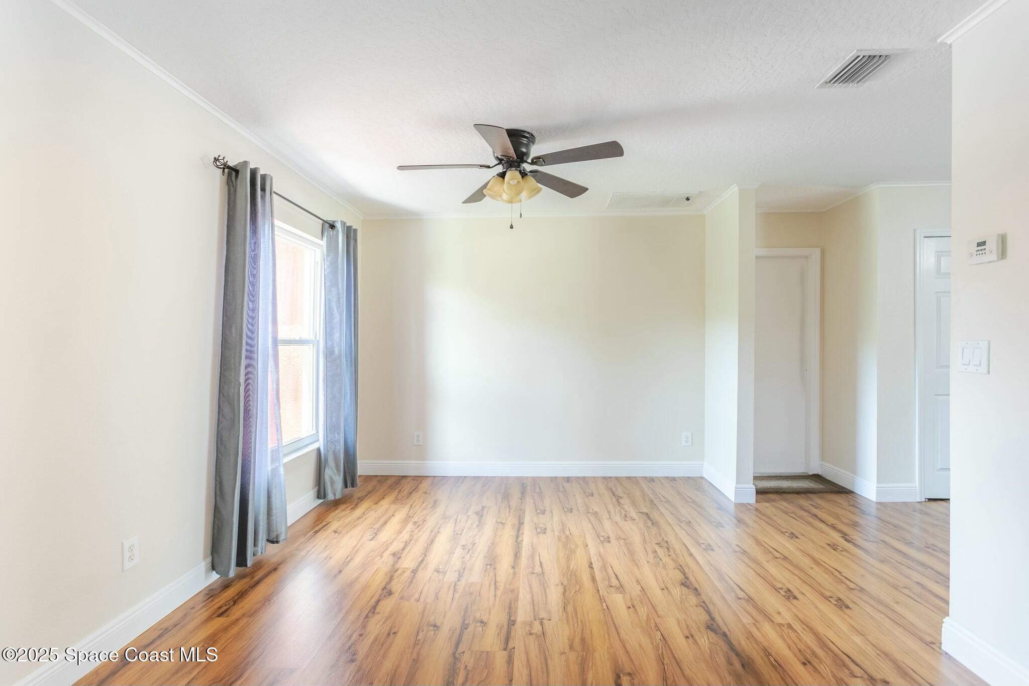 6485 Orchid Avenue Cocoa, FL 32927 - Photo 14 of 24 wooden floor in an empty room with a window