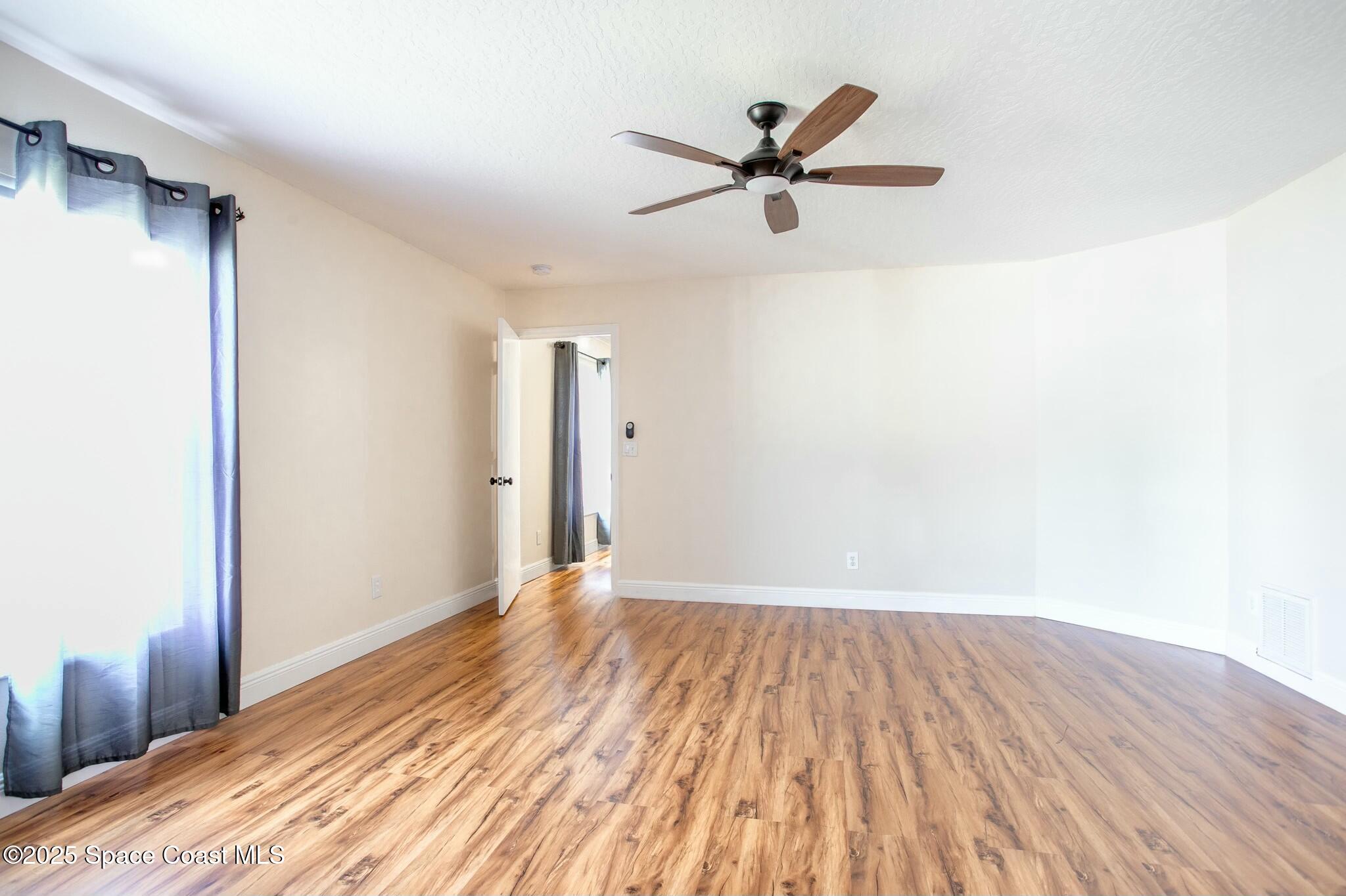 6485 Orchid Avenue Cocoa, FL 32927 - Photo 18 of 24 a view of empty room with wooden floor