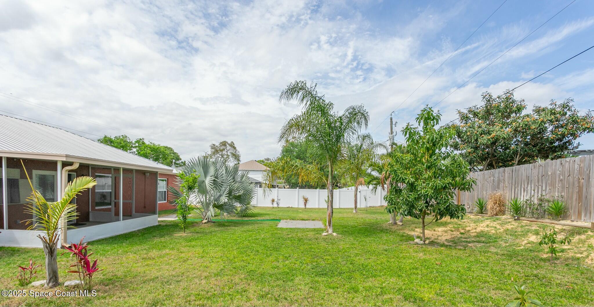 6485 Orchid Avenue Cocoa, FL 32927 - Photo 3 of 24 a view of a house with backyard and a tree