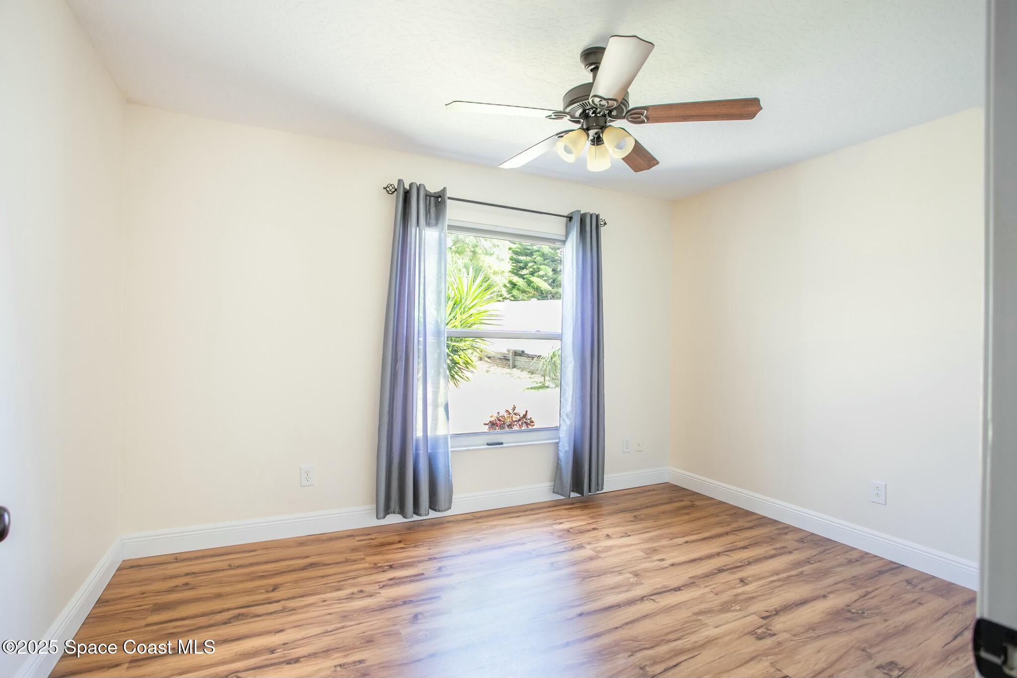 6485 Orchid Avenue Cocoa, FL 32927 - Photo 5 of 24 a view of a room with wooden floor fan and a window