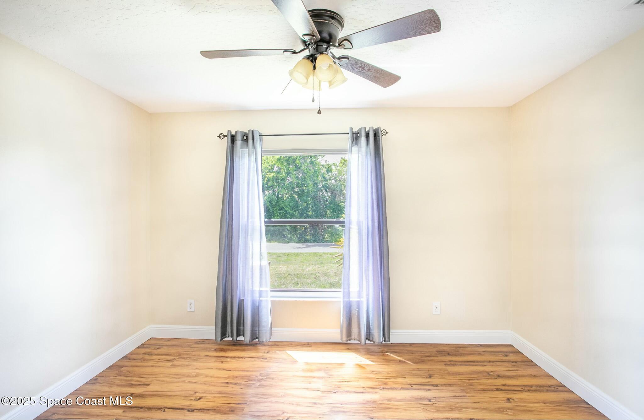 6485 Orchid Avenue Cocoa, FL 32927 - Photo 6 of 24 a view of a livingroom with a ceiling fan and window