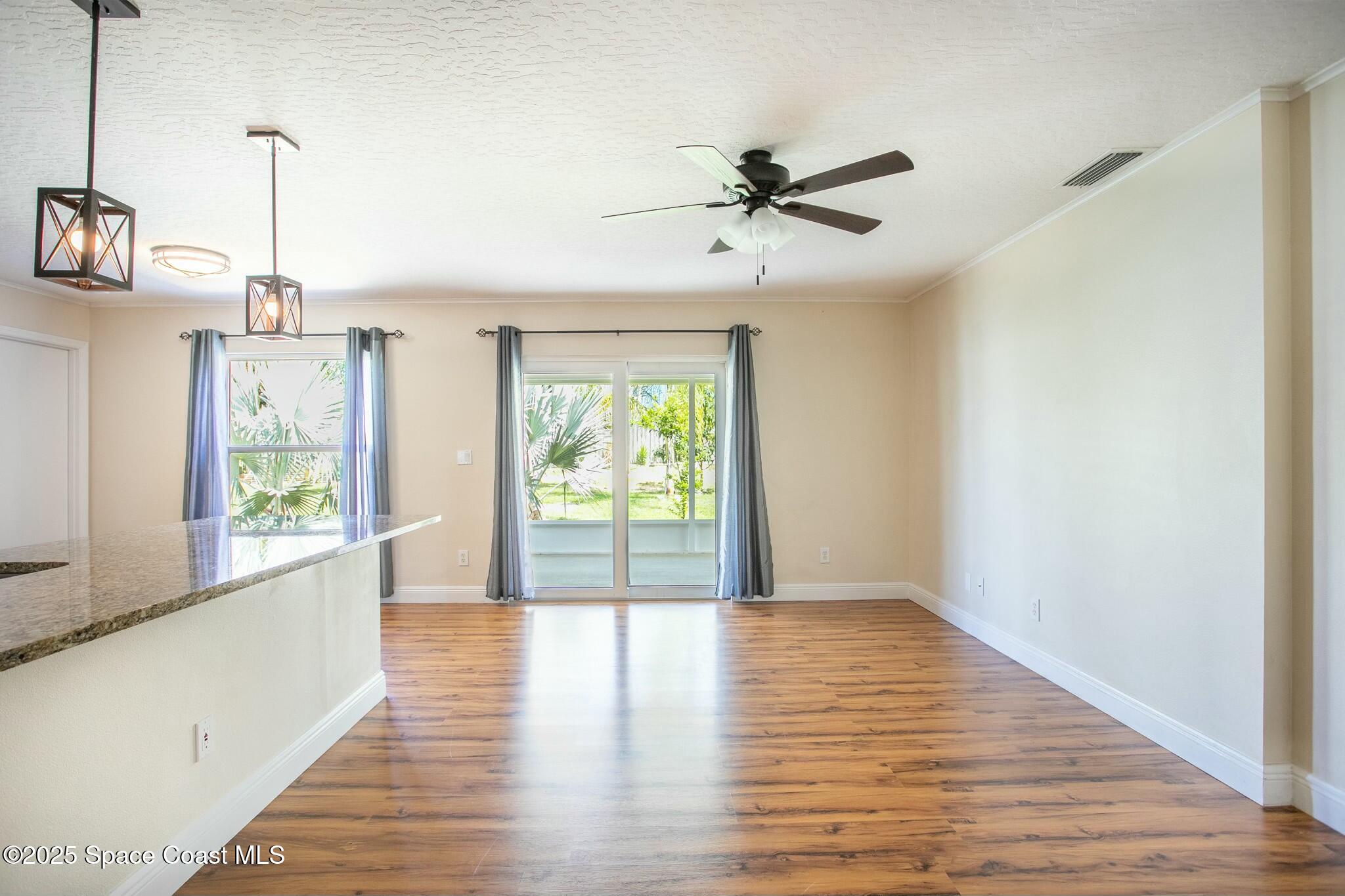 6485 Orchid Avenue Cocoa, FL 32927 - Photo 8 of 24 a view of empty room with wooden floor and fan