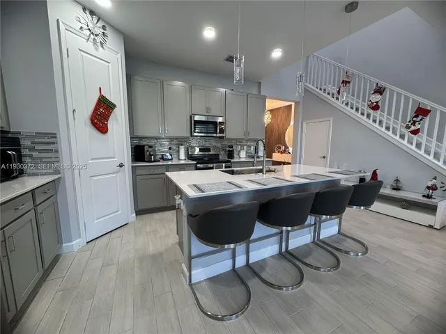 a living room with furniture a window and a flat screen tv