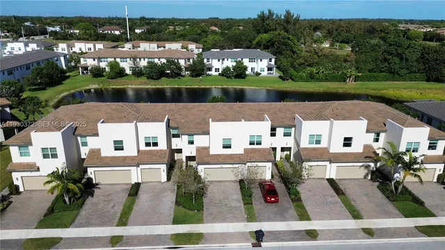 an aerial view of a house with swimming pool and outdoor seating