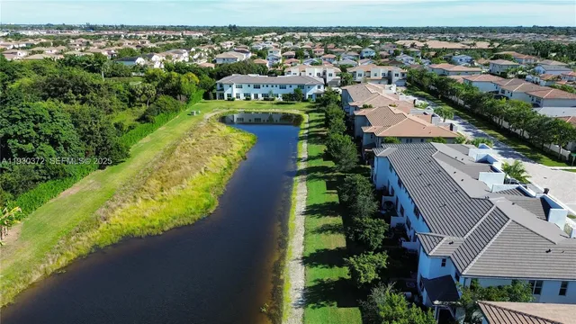 a front view of a house with garage and plants