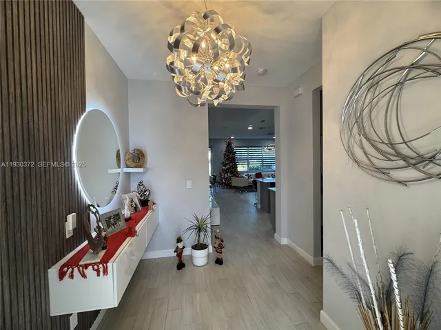 a kitchen with stainless steel appliances kitchen island granite countertop a stove top oven a sink refrigerator and cabinets