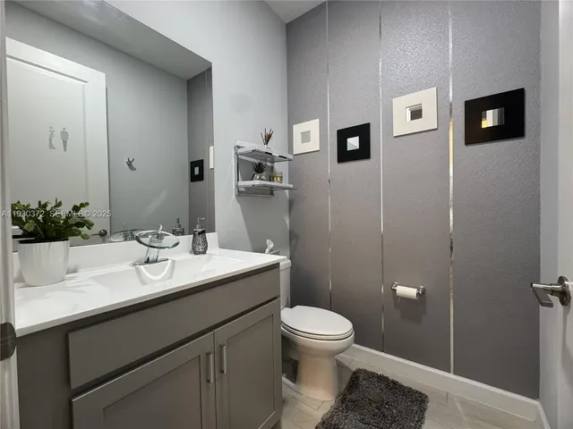 a kitchen with a dining table cabinets and appliances
