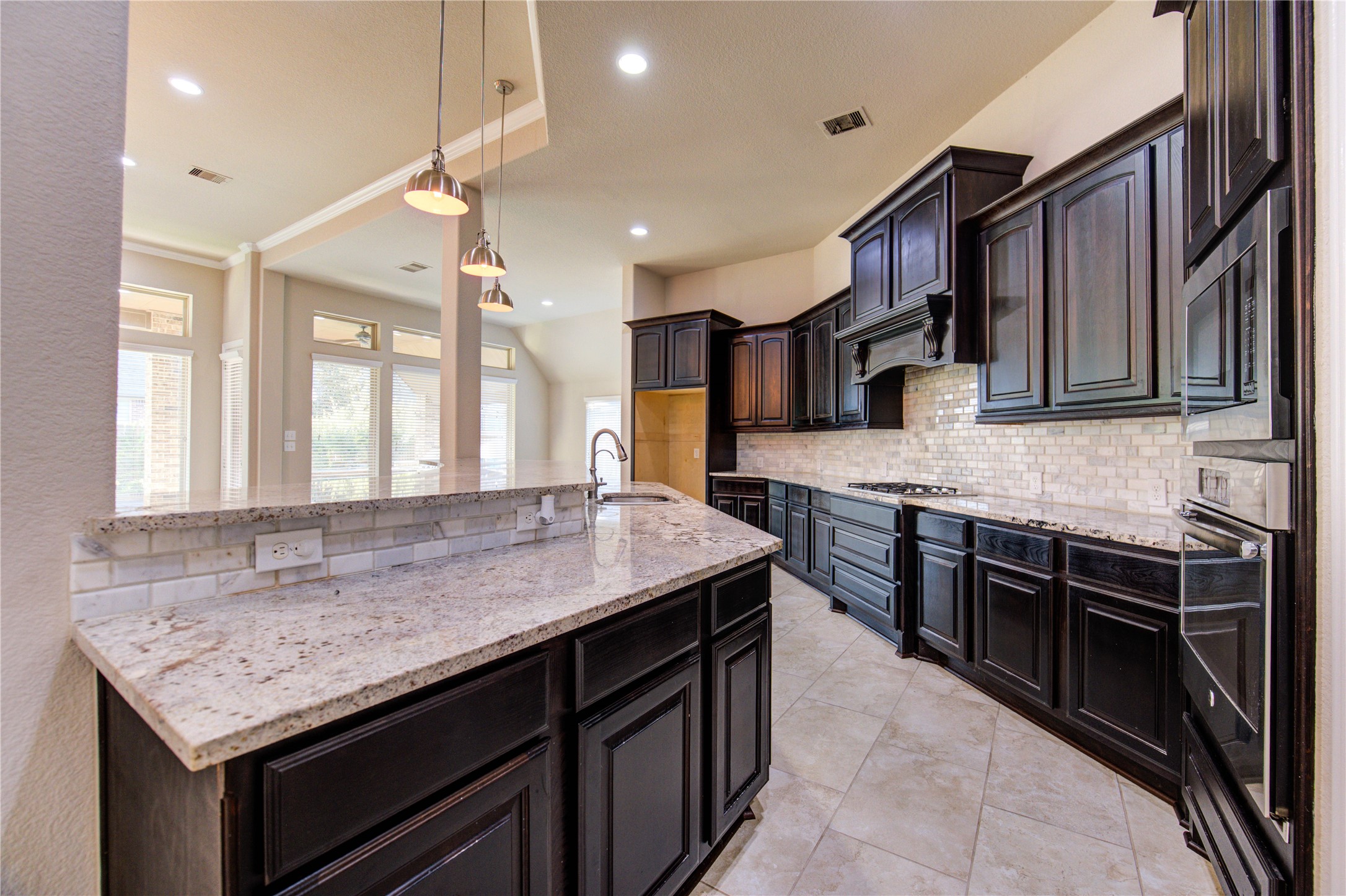 29103 Erica Lee Court Katy, TX 77494 - Photo 20 of 49 a kitchen with stainless steel appliances granite countertop a kitchen island a stove and a sink